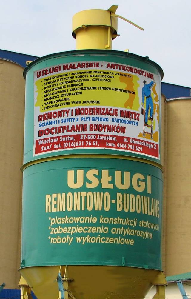 Silos z szyldem firmy — usługi malarskie i antykorozyjne